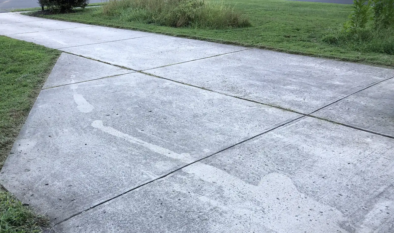 Broom-finished concrete driveway with saw-cut control joints