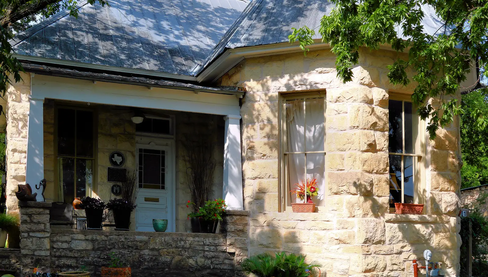 Cut limestone house with a stone porch wall in Austin, Texas